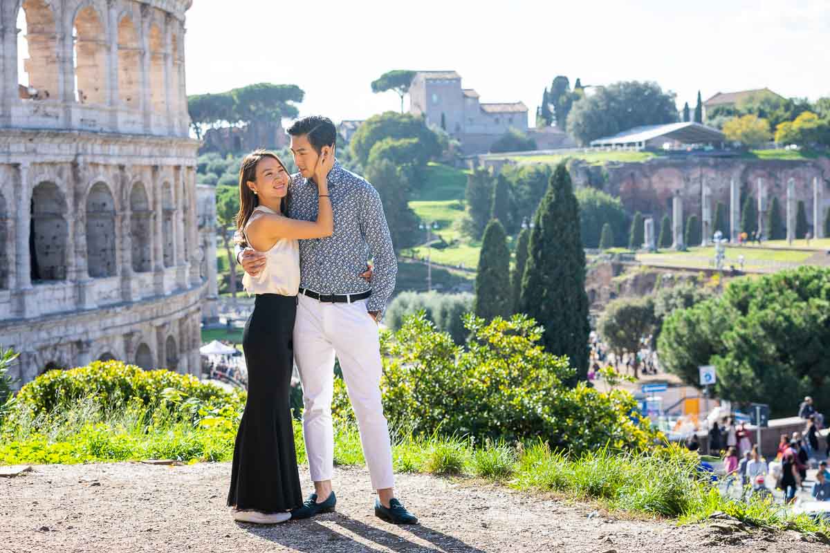 Together in Rome photo session at the Roman Colosseum overlooking the ancient monument as well as the roman forum 