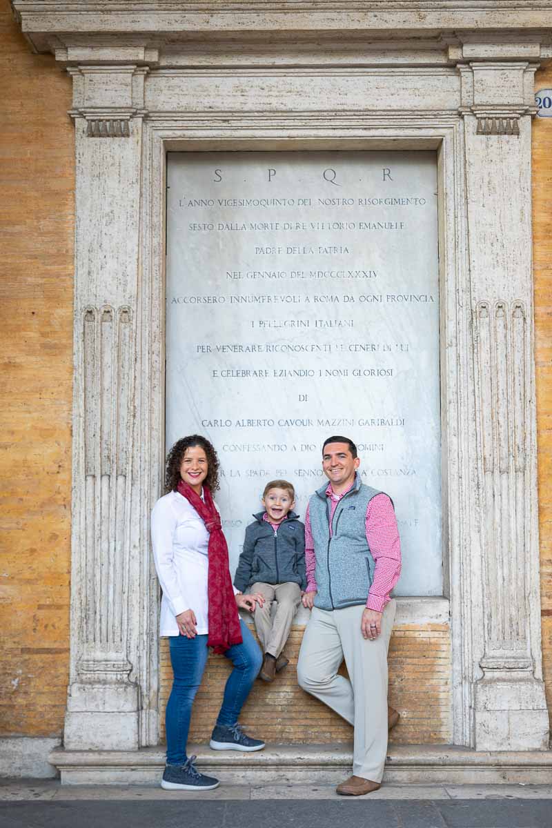 Portrait image taken in front of marble roman writing