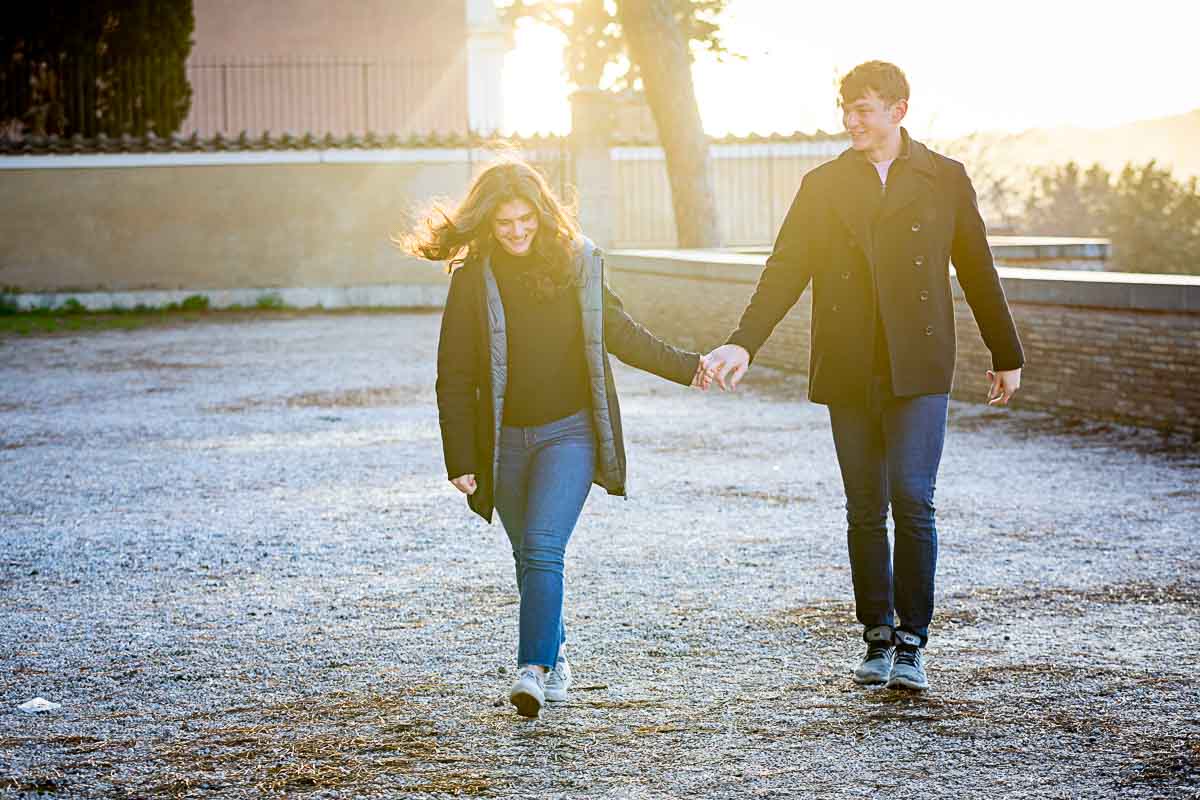 Walking together after a marriage proposal engagement session hand in hand 