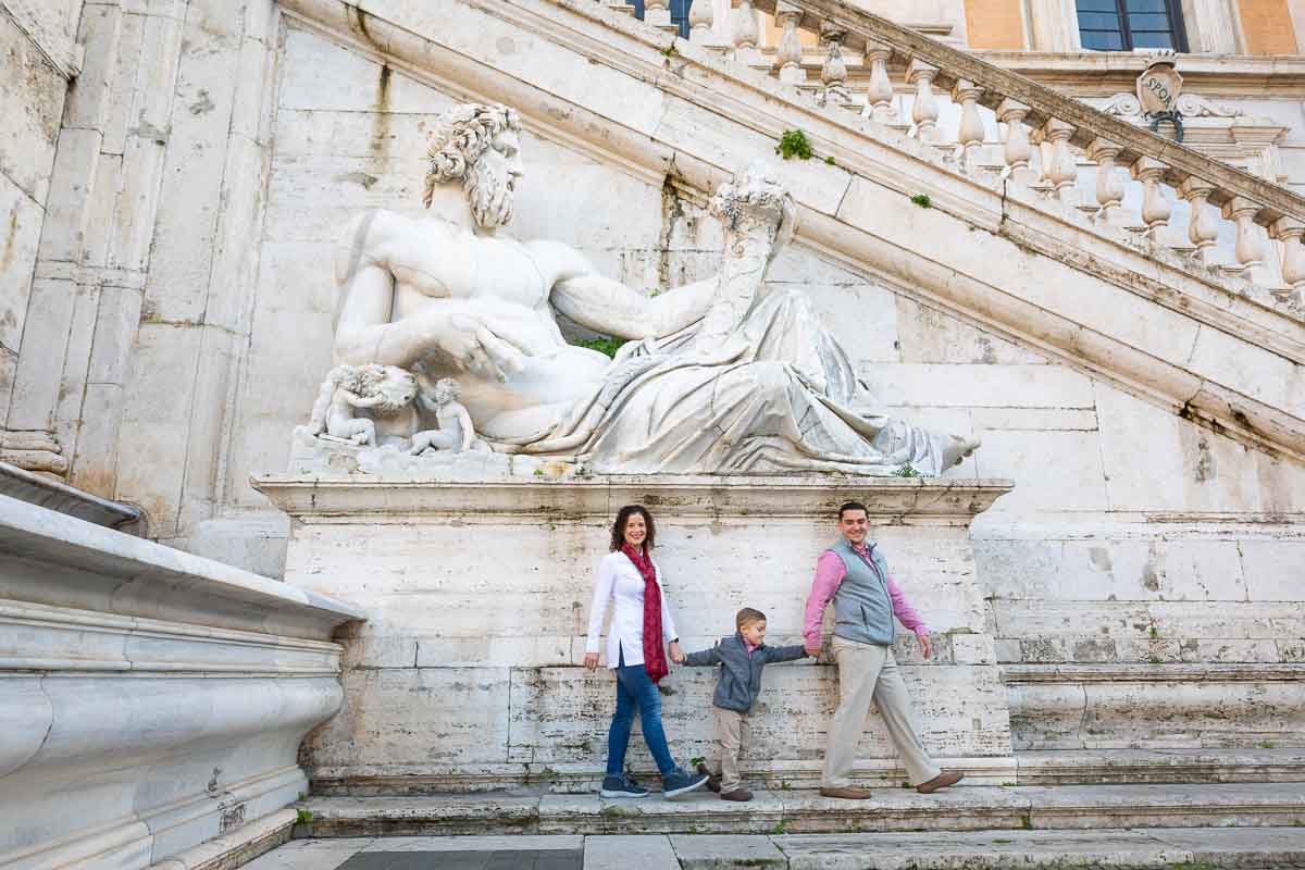 Walking under a large roman white marble statue 