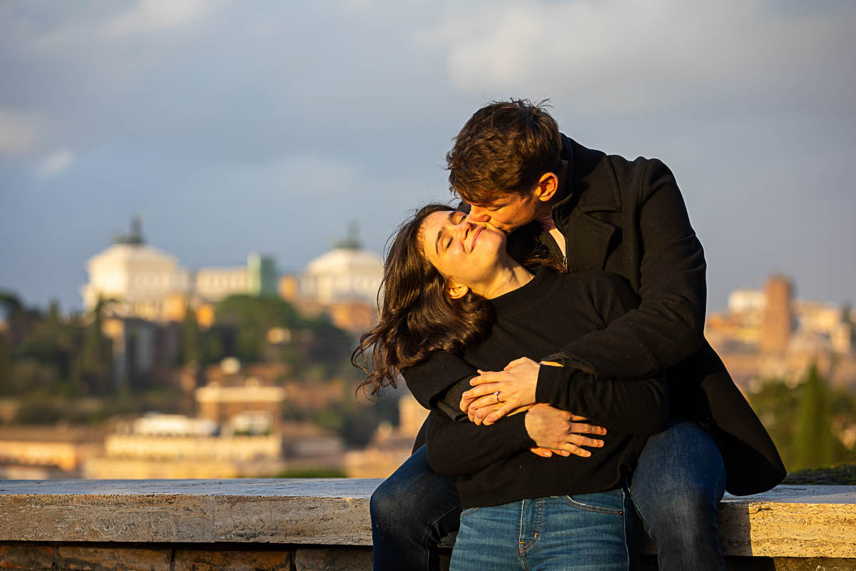 Kissing the cheek before the scenic view of the roman city 