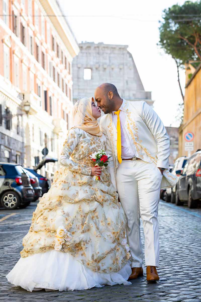 Newlyweds walking together in love. Rome, Italy. Colosseum in the far background