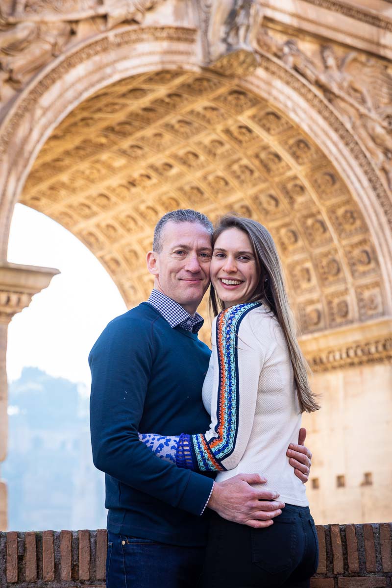 Couple close up honeymoon photo portrait taken underneath a roman arch 