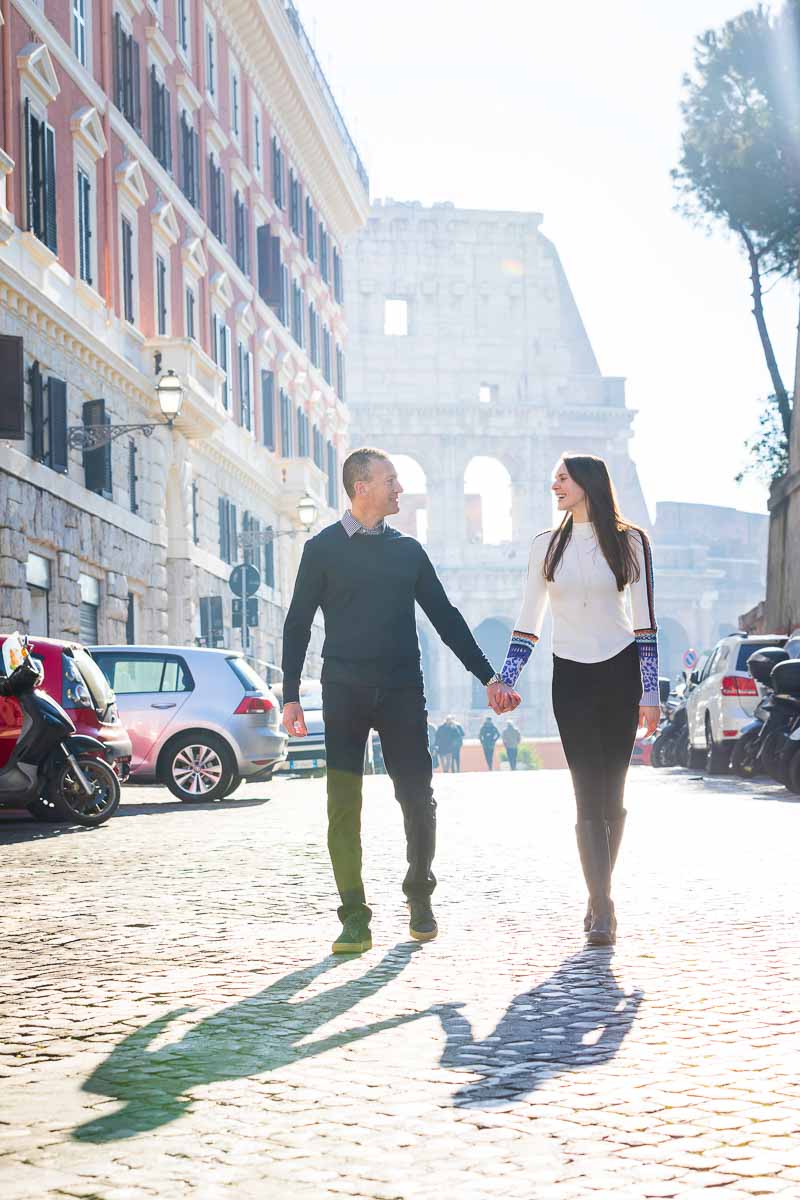 Walking together holding each other's hand with the iconic roman colosseum in the background 