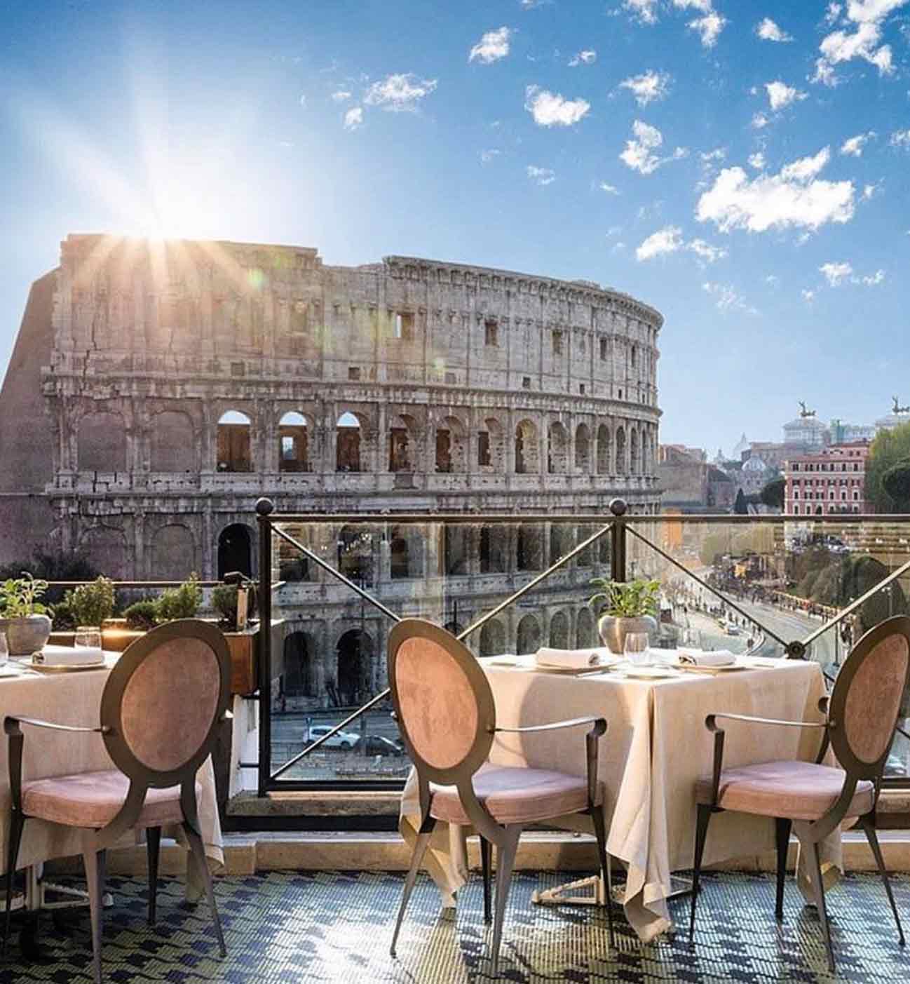 The ancient Rome city view of the Colosseum from a nearby rooftop bars in rome