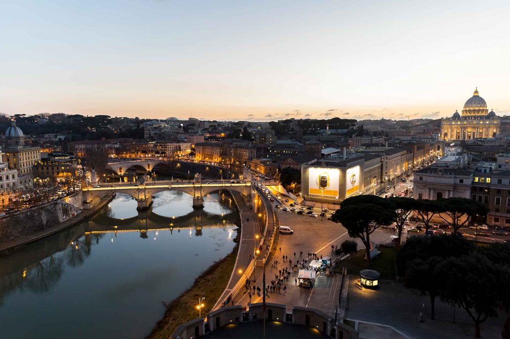 View of the Rome skyline from a rooftop bar just after sunset