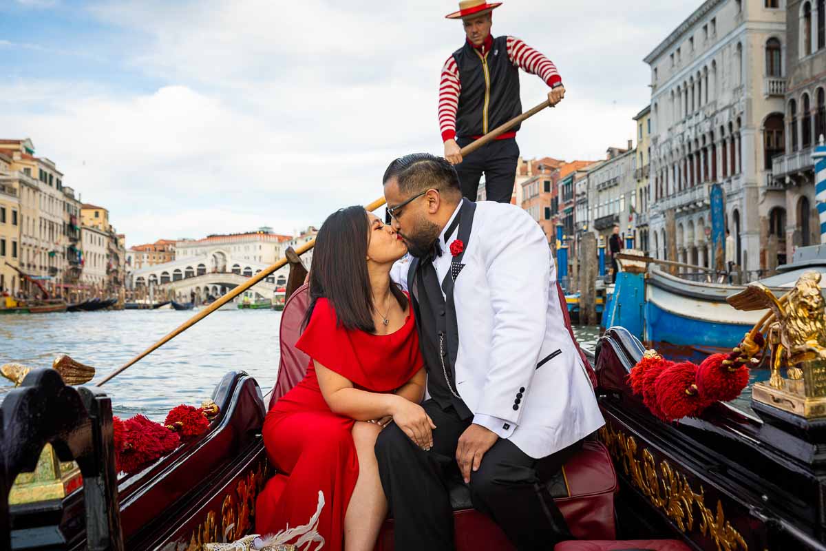 Kissing in Venice after accepting marriage proposal on a gondola ride