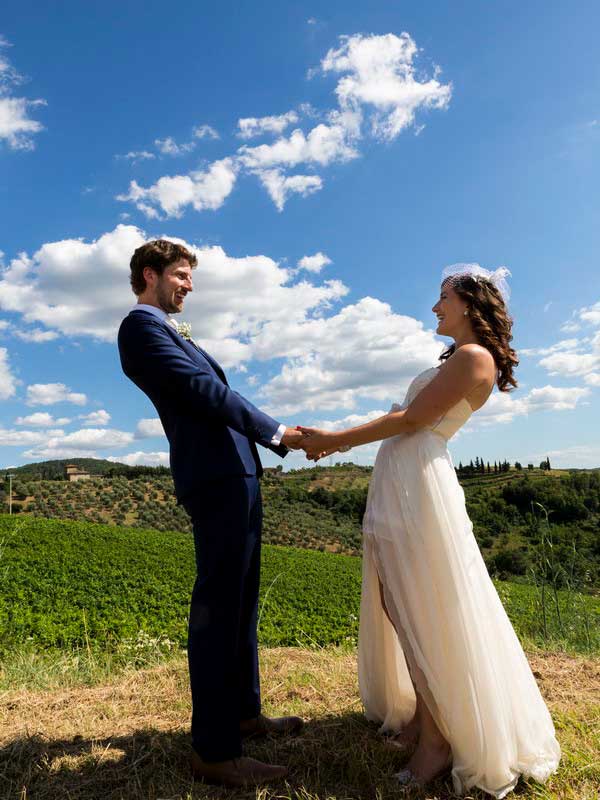 Newlywed holding hands together during a wedding photo shoot in Tuscany Italy