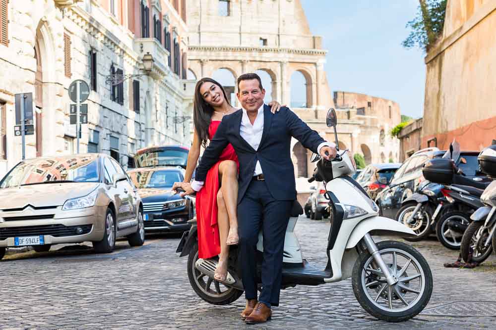 Sitting down on an Italian white scooter during a photo session 