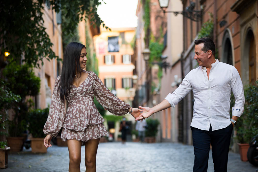 Walking holding hands in the cobblestone alleyways in Via Marghutta in Rome