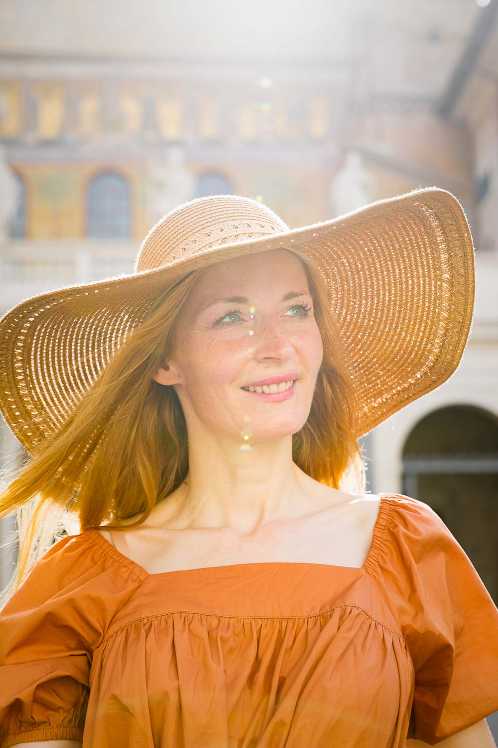 Female moedl portrait in the sun with a straw hat 