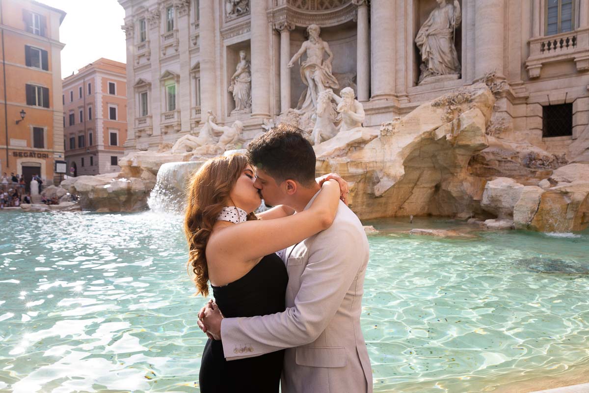 Couple kissing at the Trevi fountain in the Eternal city of Rome Italy