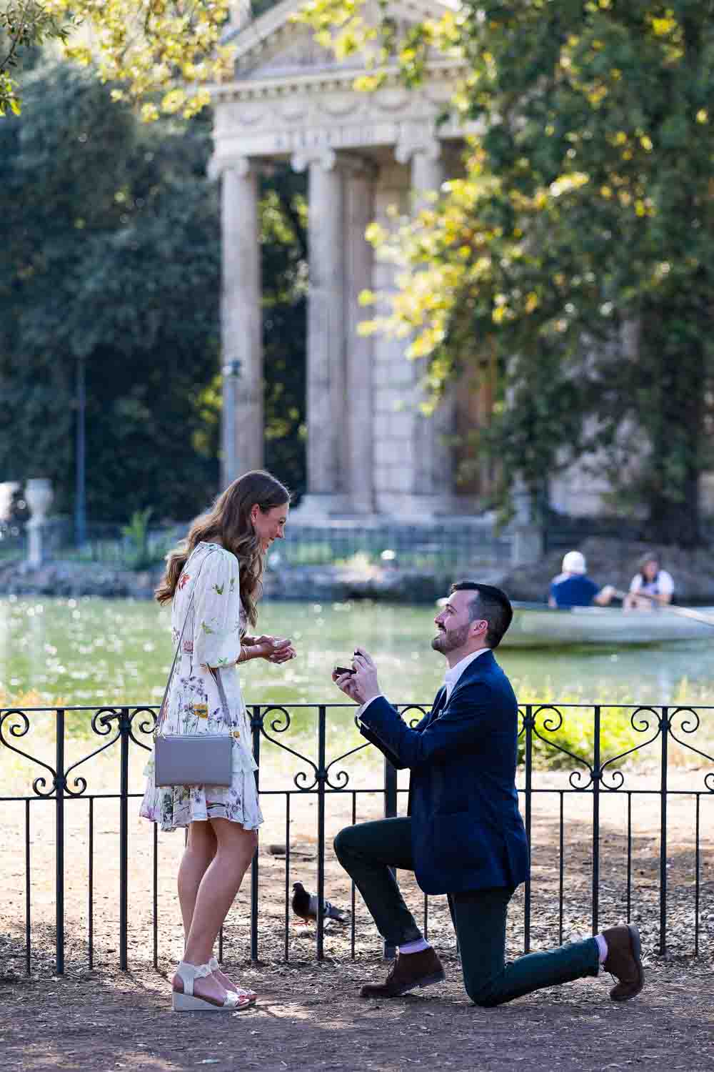 Knee down wedding proposal in Rome photographed at the Villa Borghese park in Rome Italy