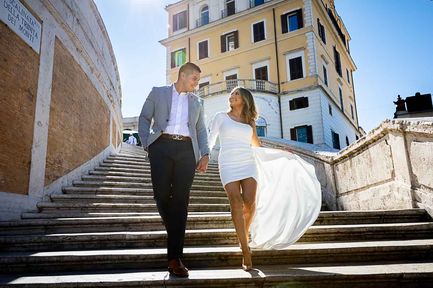 Couple photography in Rome while walking down the spanish steps by the Andrea Matone photographer studio