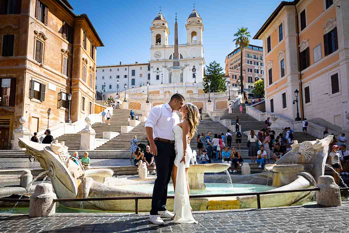 Kissing in rome at Piazza di Spagna at the bottom of the water fountain