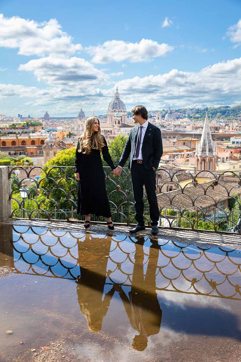 Double portrait of a couple in front of the amazing view of Rome together with the reflection counterpart