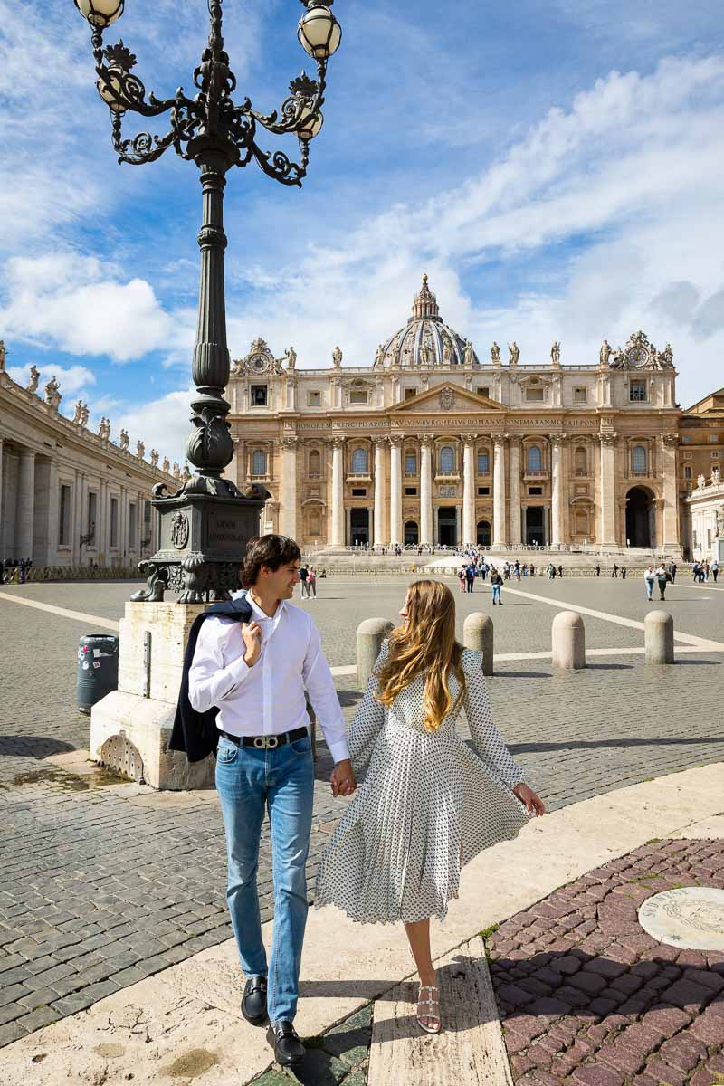 Casually walking hand in hand in Saint Peter's square in the Vatican Italy