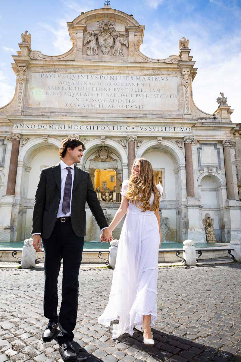 Couple holding hands in hands and walking across the street during a photography session