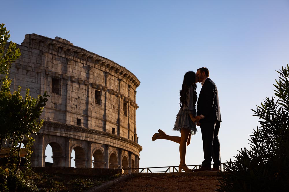 Silhouette picture of a couple kissing before the Colosseum in the ancient city of Rome Italy 