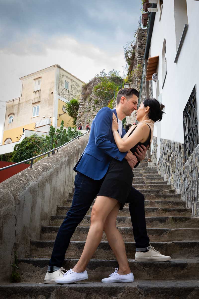 Posed image of couple dipping on ancient stairs