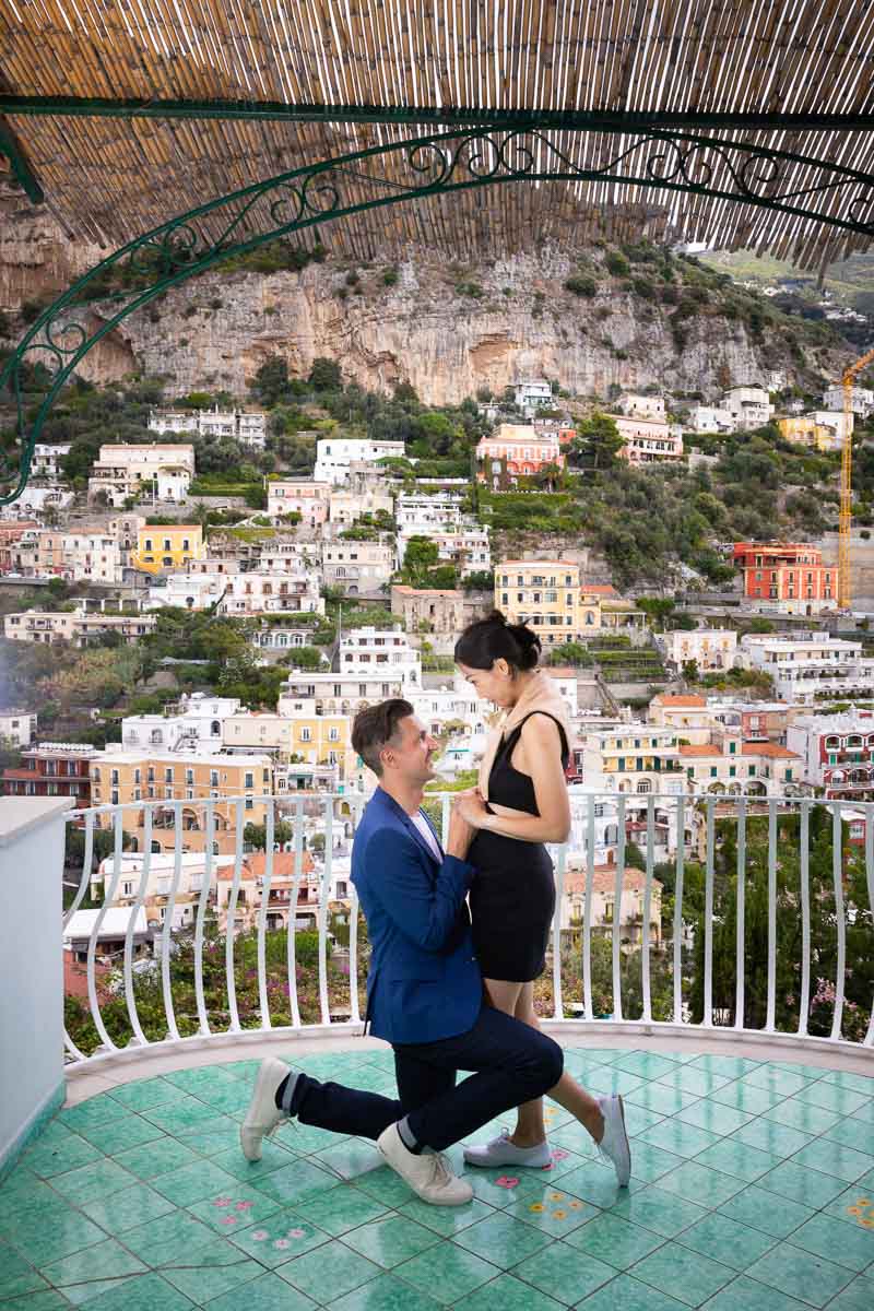 Asking the big question of getting married on a balcony overlooking Positano's houses 