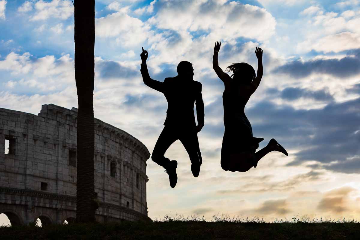 Jumping in the air at the Colosseum during a photoshoot in Rome