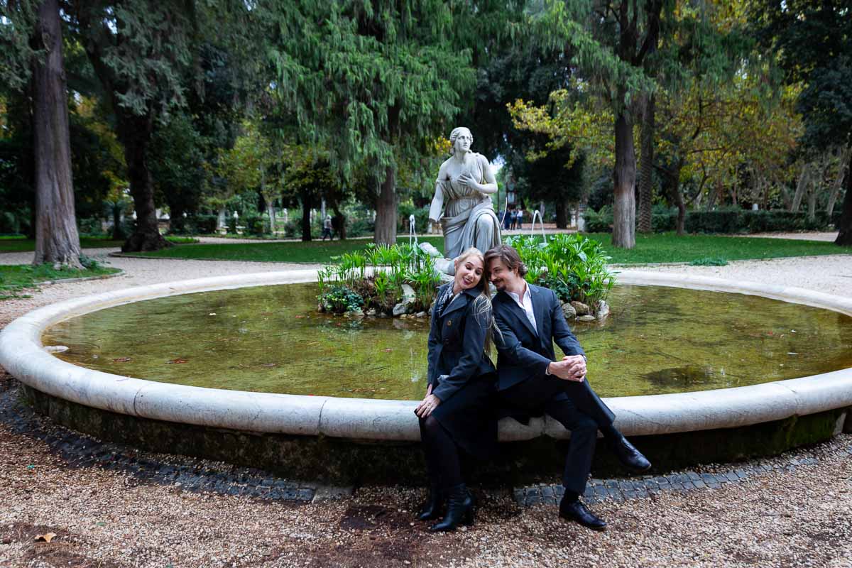 Sitting on the edge of a circular water fountain 