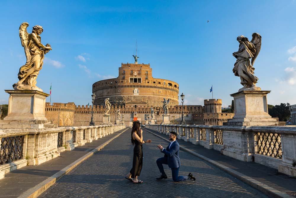 Surprise wedding proposal candidly photographed on the Castel Sant'Angelo bridge in Rome Italy