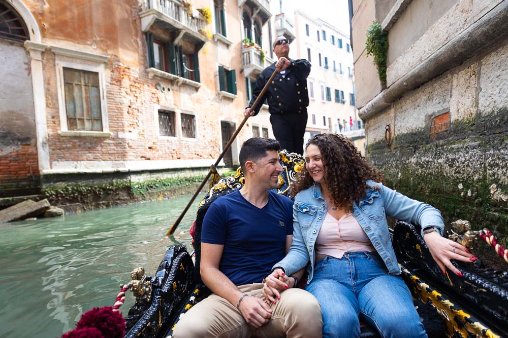 Couple together during a gondola ride in the canals 