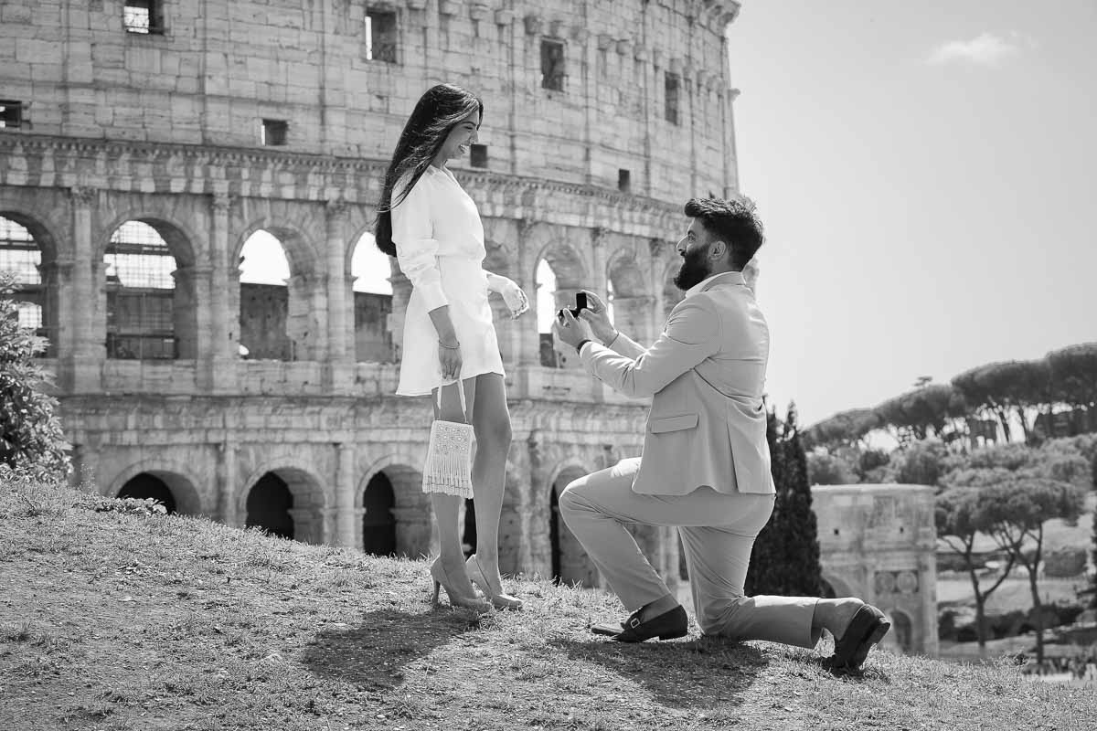 Black and white photography version of a surprise wedding proposal photographed in Rome by the Roman Colosseum