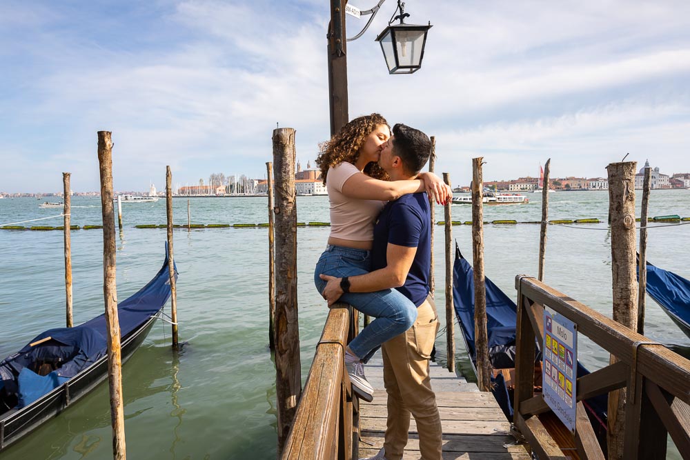 Taking engagement pictures in the gondola docks by the open sea