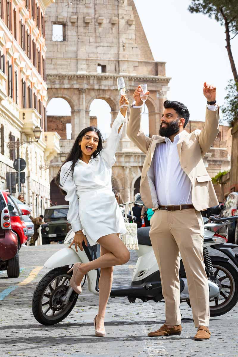 Just engaged in Rome couple celebrating together with hands in the air