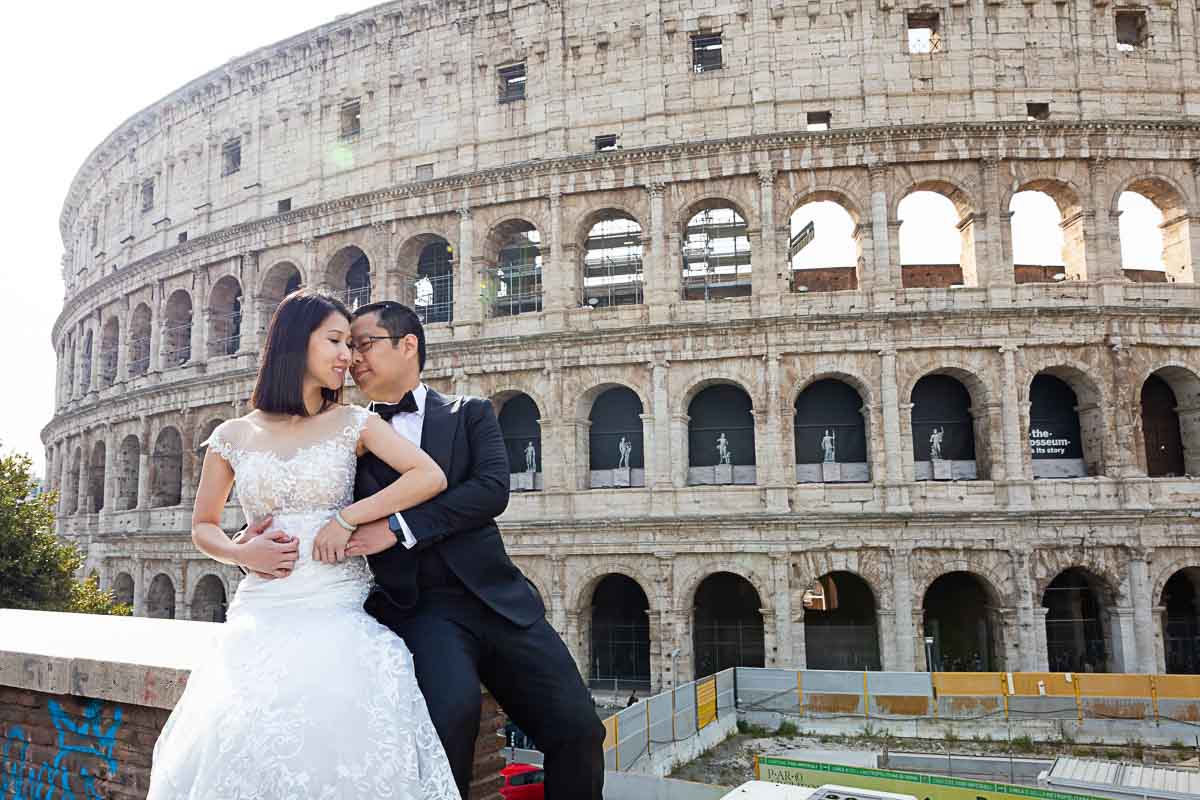 Bride and groom taking pictures at the Coliseum in Rome Italy