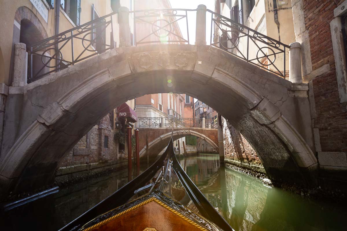 On a Gondola Ride passing through smaller canals under Venetian bridges