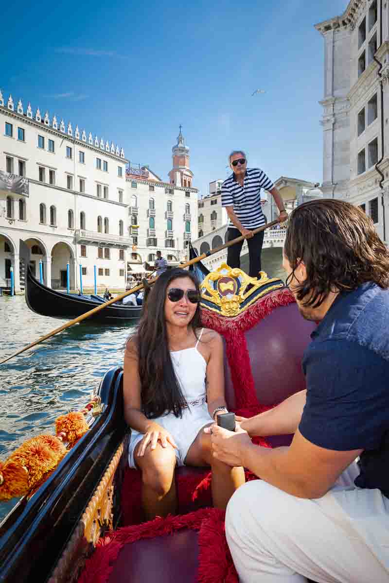 Surprised by a wedding proposal on a gondola ride in Venice's Grand Canal and Rialto bridge as backdrop