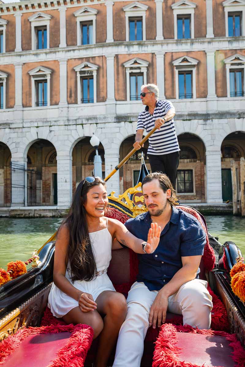 Looking at the engagement ring while riding on a gondola after a surprise proposal in Venice 