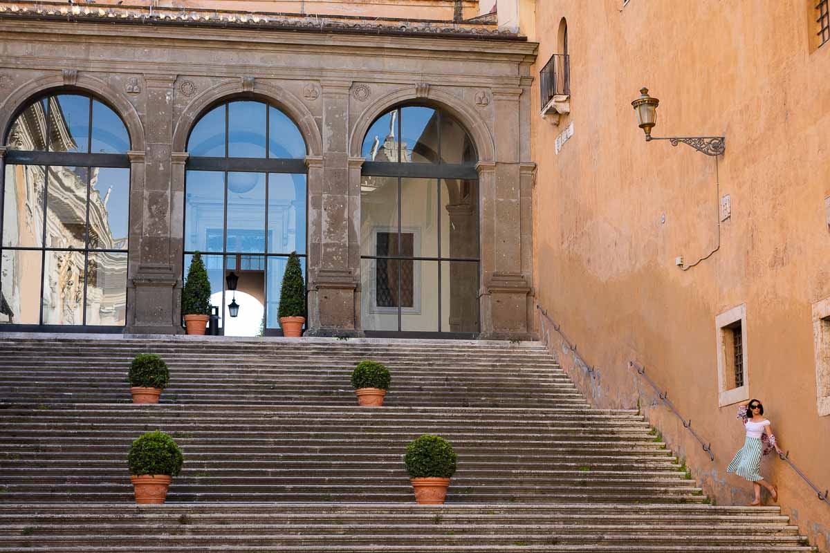 Portrait taken on the staircase of Campidoglio square where the subject is small in the picture frame contextualizing the spaces 