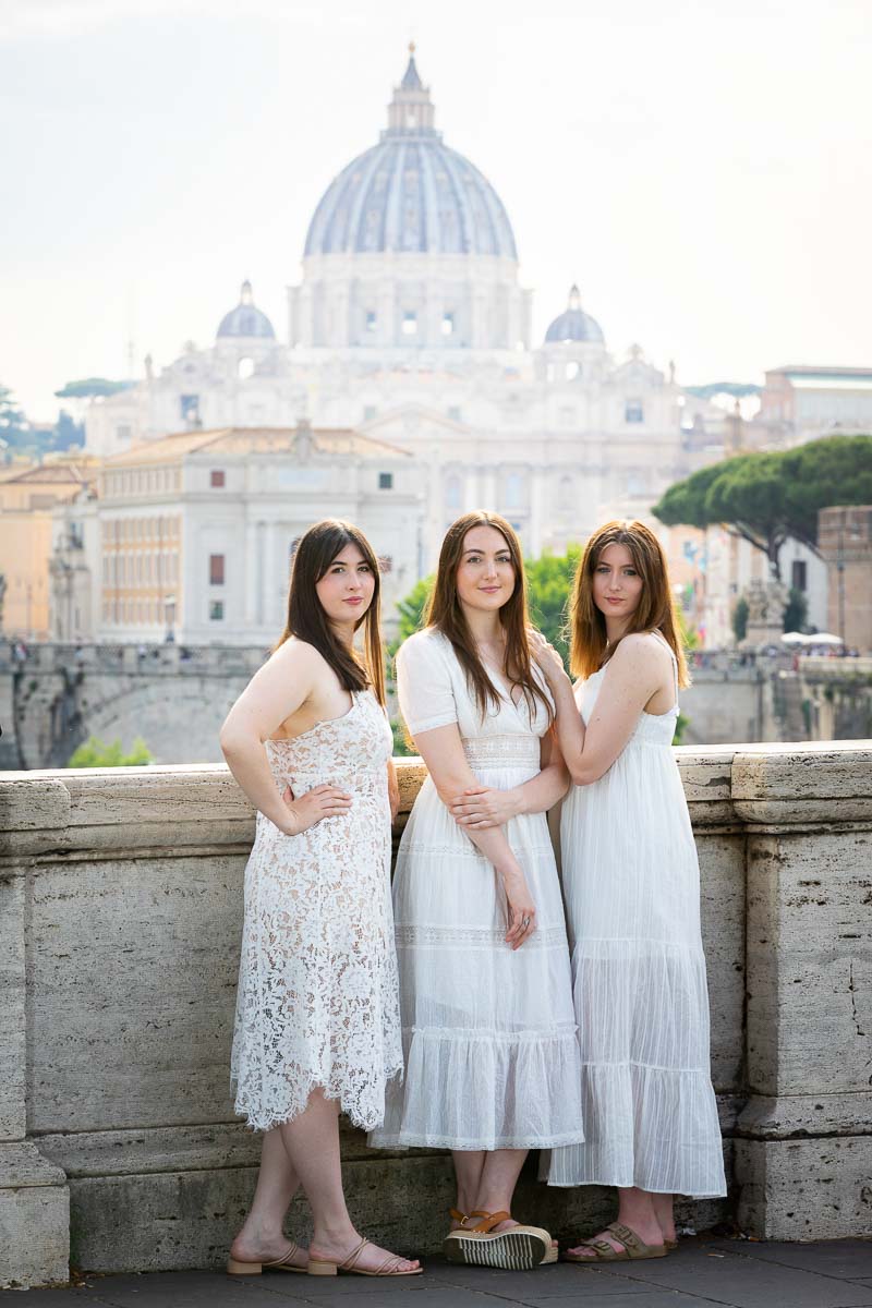 Posed portrait of 3 models posing in front of Saint Peter's dome cathedral in the background