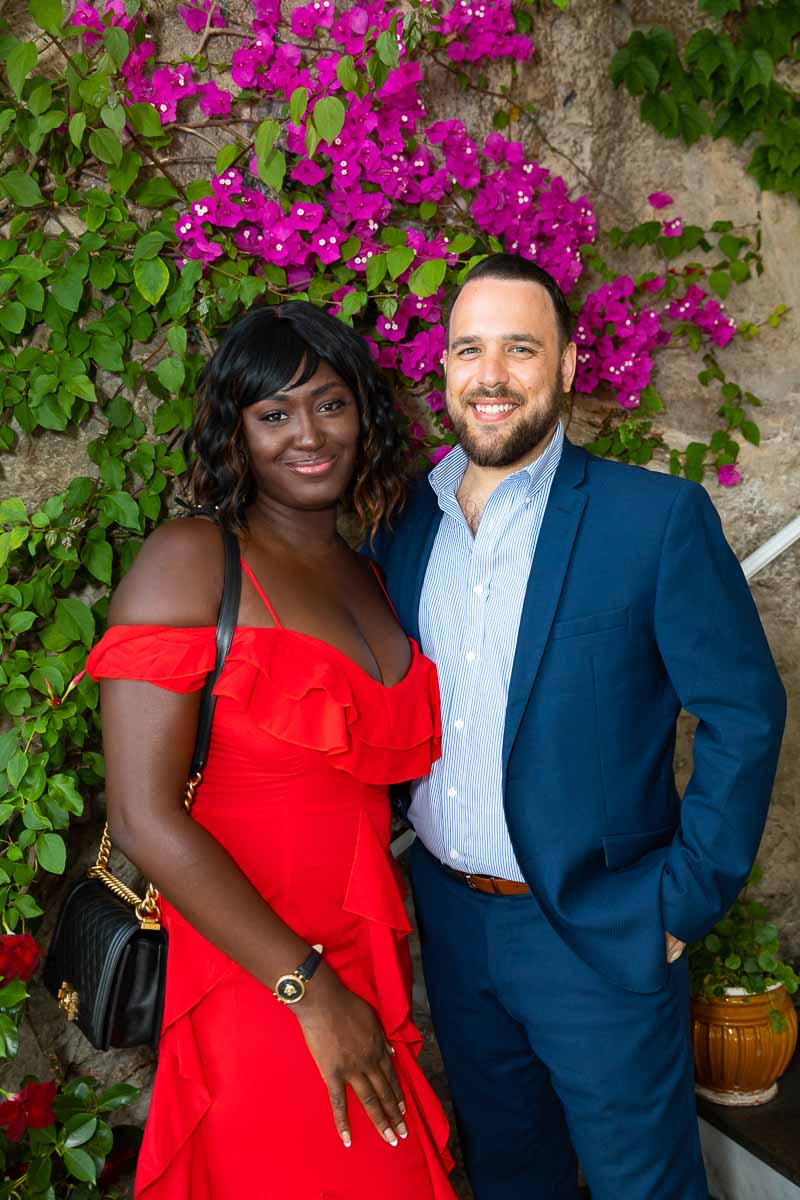 Coupe portrait taken in front of colorful flowers on the staircase of the restaurant