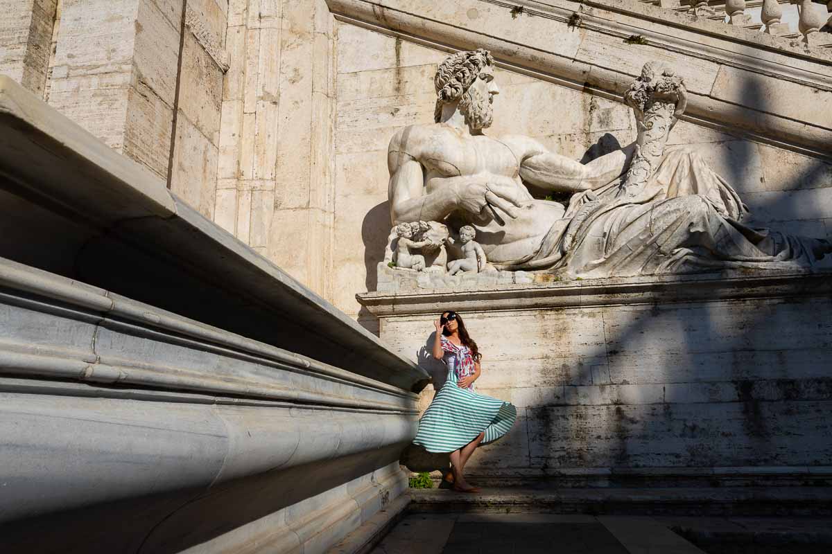 Creative and unique portrait picture of a photography model photographed under a marble statue in Rome 