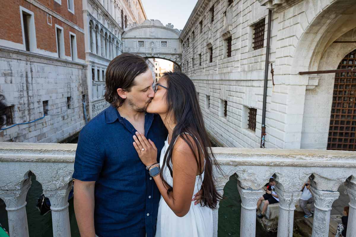 Kissing in front of Ponte dei Sospiri in the city of Venice Italy