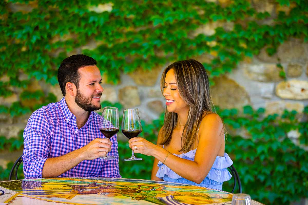 Coupe toasting and celebrating their engagement with red wine tasting 