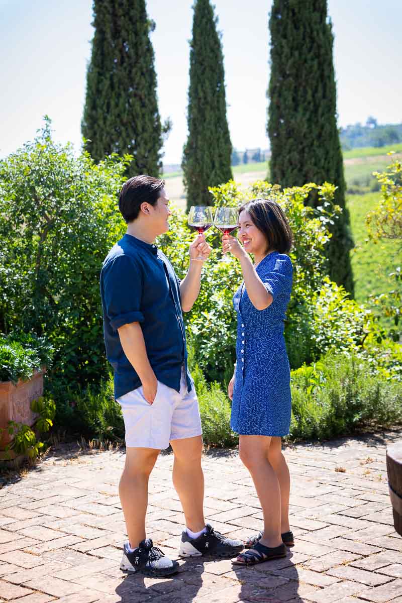 Toasting engagement together in the courtyard after the Tuscany Winery Proposal