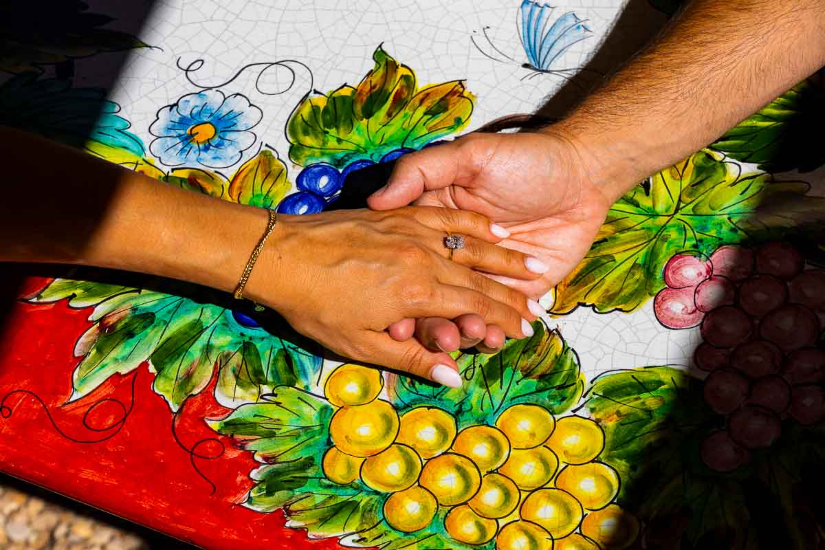 Holding hands while wearing the newly placed engagement ring. Vineyard Wedding Proposal in Tuscany. Toasting in a Vineyard after a Wedding Proposal in Tuscany