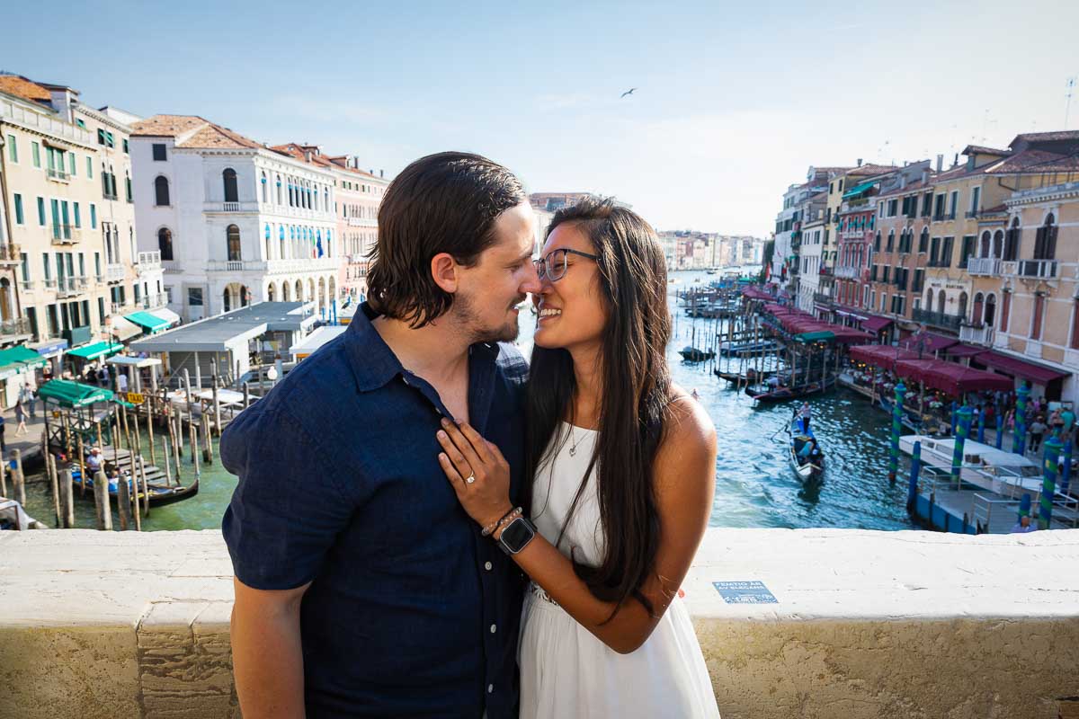 Couple portrait picture taken on the Rialto bridge and Canal Grande water canal as backdrop