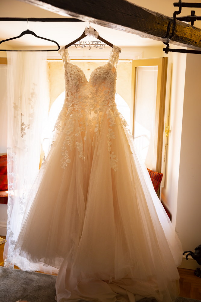 Photographing the Wedding Dress while hanging from the wooden ceiling