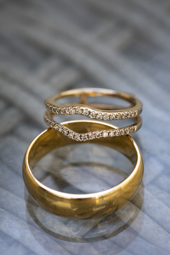 The wedding rings photographed on a glass table 