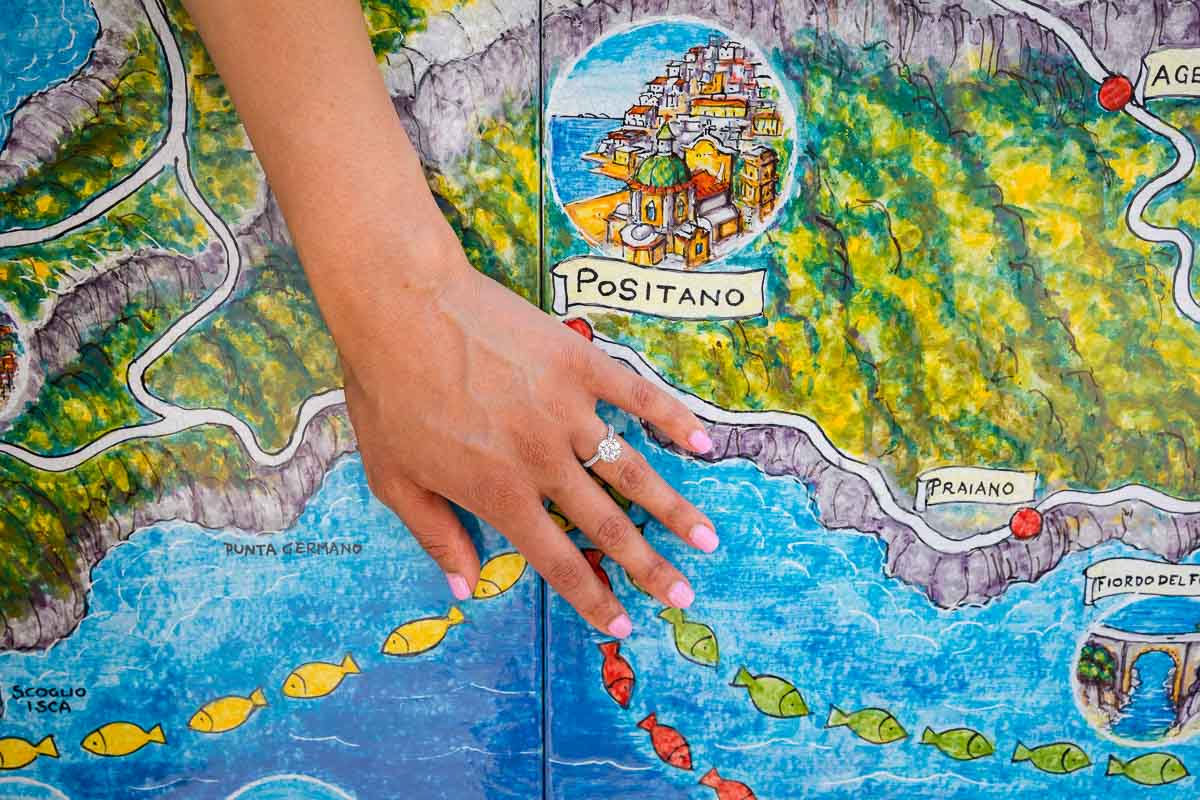 Engagement ring photos taken over the map of Positano on the Amalfi coast