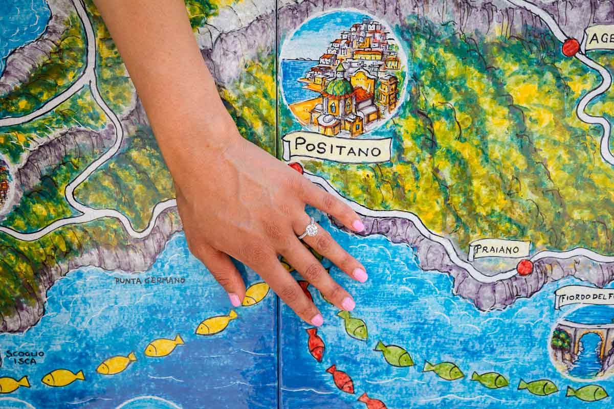 Engagement proposal ring photos taken over the map of Positano on the Amalfi coast. Wedding proposal 