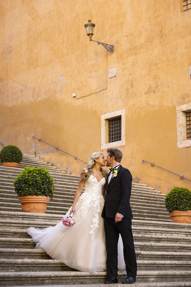 Just married in Piazza del Campidoglio. Portrait on the staircase